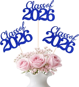 Close-up of Class of 2026 blue glitter cake toppers in a floral vase decoration