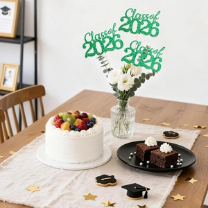 Close-up of Class of 2026 green glitter cake toppers set for graduation dessert decor