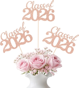 Close-up of three rose gold Class of 2026 glitter cake toppers in a flower vase