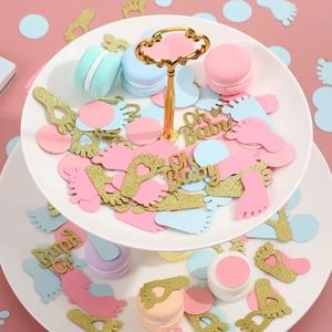 Close-up of Oh Baby glitter confetti and baby footprint shapes on a dessert stand