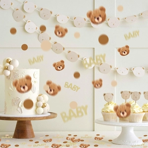 Close-up of golden glitter BABY letters and teddy bear confetti for baby shower decor