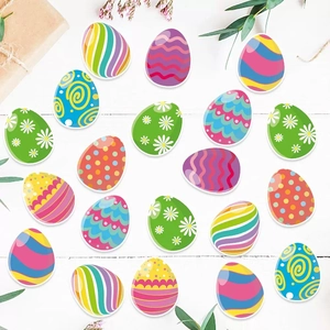 Easter egg confetti decorations with colorful patterns on white wood background