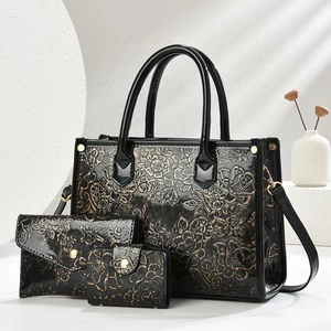 3-piece black tote bag set with golden floral embossing and polished leather texture