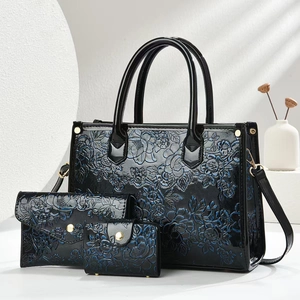 Three-piece luxury embossed tote bag set with floral patterns and gold hardware in black