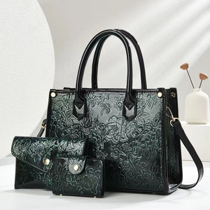 Green embossed faux leather 3-piece set featuring a large tote bag and two clutches