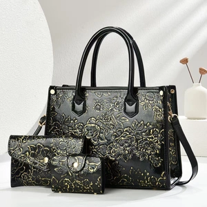 Three-piece black handbag set with golden floral embossing, long wallet and card holder