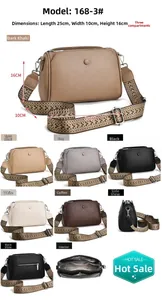 Detail of lychee textured crossbody bag with three main zip compartments and woven strap