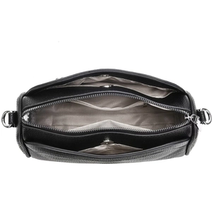 Internal view of black pebble leather crossbody bag with three compartments and silver hardware