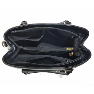 Detail view of large handbag interior with multiple compartments and gold zipper