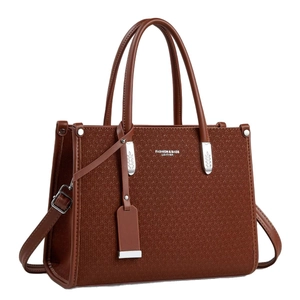 Brown woven leather tote bag with top handles and adjustable shoulder strap