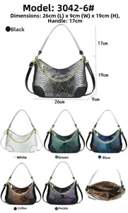 Detail view of snakeskin embossed handbag with gold chain and interior structure