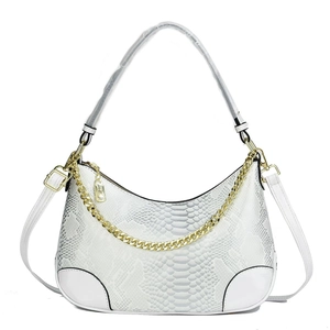 Detail of white snakeskin hobo bag with gold decorative chain and dual straps