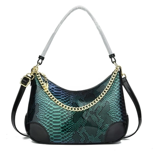 Blue-green snakeskin baguette bag with black patent trim and golden chain strap