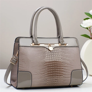 Taupe crocodile embossed leather handbag with top handles and adjustable shoulder strap