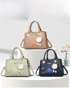 Detailed embroidery of flowers and butterflies on luxury PU leather handbags in multiple colors
