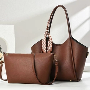 Close-up of brown litchi leather tote bag set with geometric silk scarf and crossbody bag