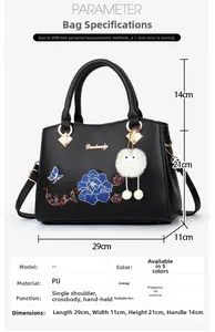 Detail of floral embroidery on black PU leather handbag with elegant golden hardware accents