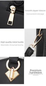Close-up of golden metal zipper and detachable hardware on black pebbled leather bag