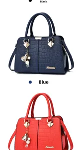 Close-up of stylish faux crocodile leather handbags with decorative floral charms and logo