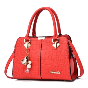 Elegant red crocodile textured tote bag for women with gold hardware and flower charm