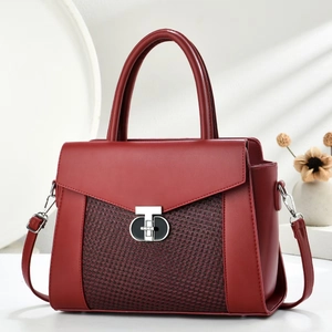 Elegant wine red leather handbag with woven texture and silver T-lock detail