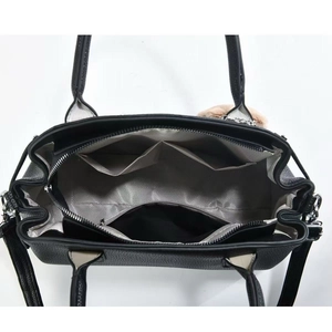 Interior detail of black leather tote bag with grey lining and zippered compartment