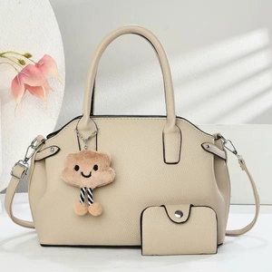 Close-up of cream shell tote bag with litchi texture and matching small coin purse