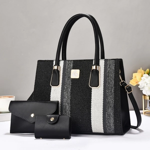 Three-piece set featuring large striped tote bag with elegant gold swan logo and clutch bag