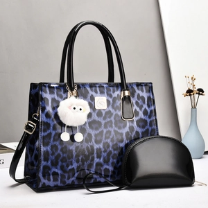 Three-piece women's blue leopard print tote bag with small purse and charm pendant