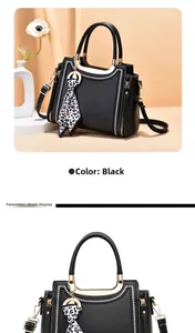 Detail view of black PU leather handbag with V-stitch design and leopard print scarf charm