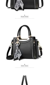Detail of black crossbody bag with white wavy stitching and leopard print scarf charm