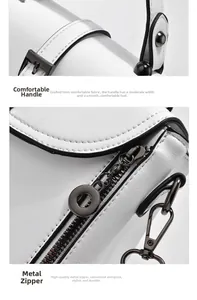 Close-up of durable white leather hand strap and smooth metallic zipper hardware details