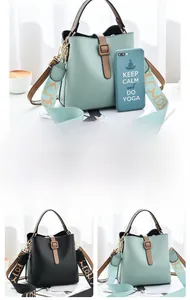 Detail of mint green and black leather bucket bags with decorative printed strap