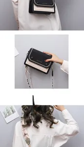 Détails du sac bandoulière bicolore avec large sangle et finitions dorées chic