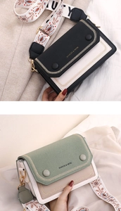 Détail du sac bandoulière bicolore avec surpiqûres en V et sangle brodée de style ethnique