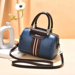 Classic blue woven leather Boston bag with vertical striped webbing and brown handles