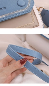 Détail du sac bandoulière aux couleurs contrastées avec cuir texturé et coutures décoratives