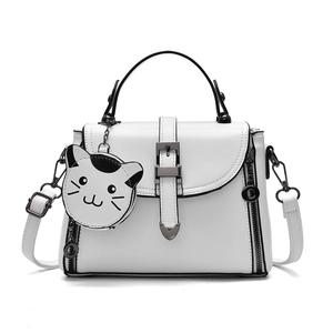 White minimalist crossbody bag for women with cat charm and pebbled leather texture