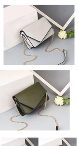 Detail view of mini chain crossbody bags in grey and olive green with metal logo