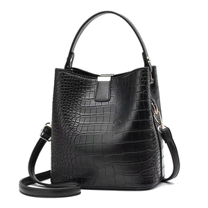Chic black crocodile embossed bucket bag with top handle and adjustable shoulder strap