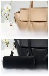 Close-up of pebble leather texture and gold-stamped logo on tote bag and wallet set