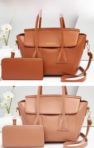 Detail view of two-piece tote bag set with matching zip wallet in brown and beige PU leather