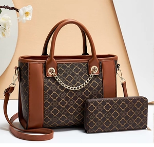 Detail view of large PU tote bag and wallet set with vintage clover monogram pattern