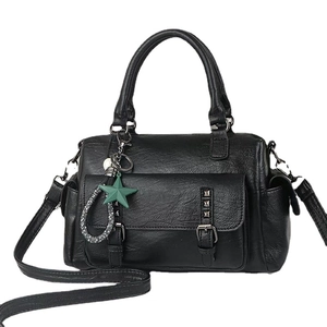 Classic black Boston handbag with silver rivets and green star charm in a crossbody style