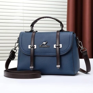 Detail of blue pebble grain leather handbag with brown handles and kangaroo logo