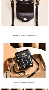 Detail of a black crossbody phone bag with gold magnetic buckle and cute cow pendant