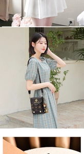 Detail of vintage brown crossbody phone bag with monogram pattern and bear charm