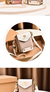 Detail of a minimalist cream white mini crossbody phone bag with a gold floral logo