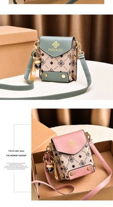 Detail view of mini crossbody phone bags in pastel colors with cartoon charms and gold hardware