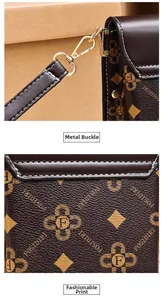 Detail of high-quality gold metal lobster clasp and vintage monogram print on brown leather
